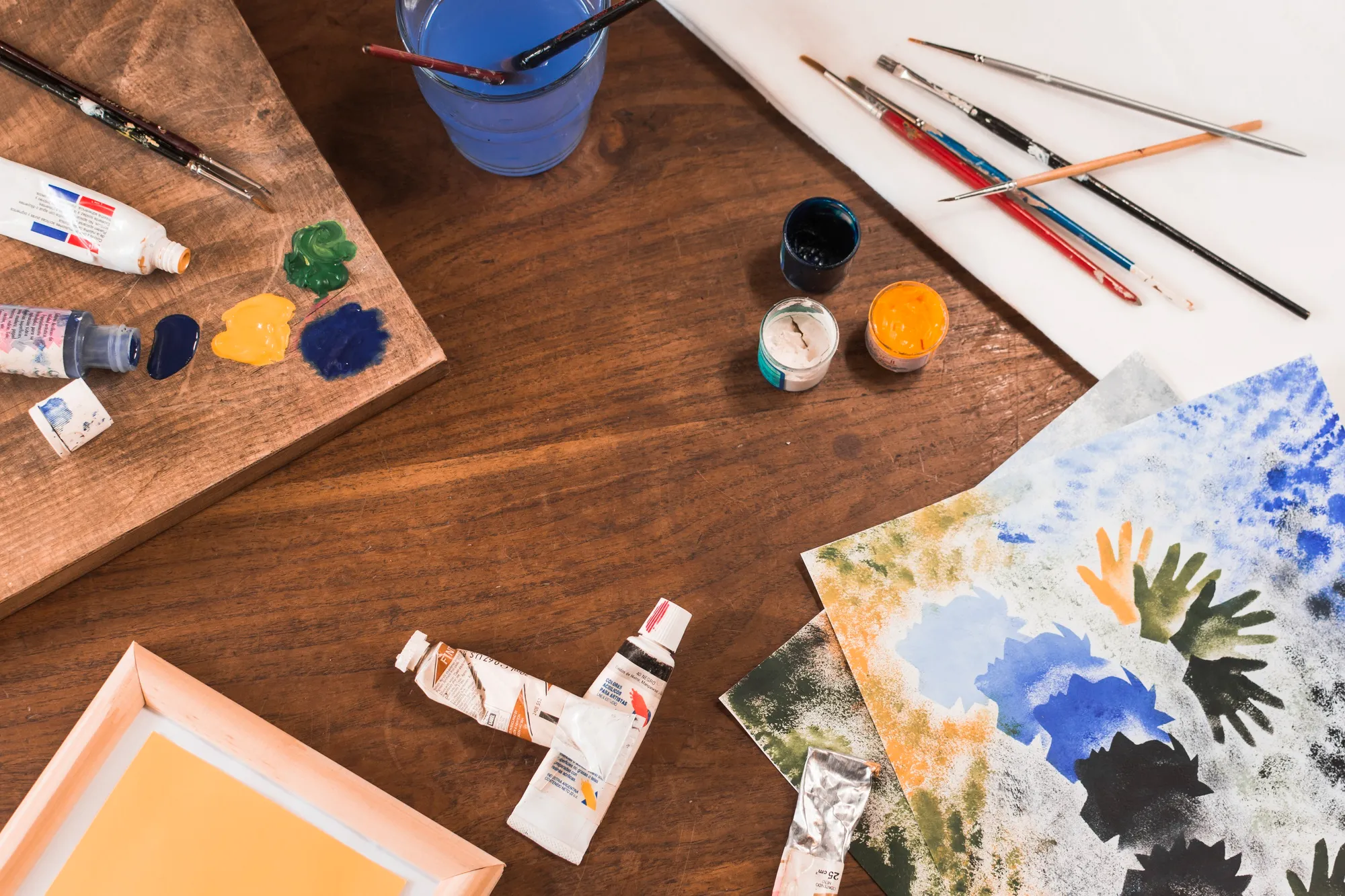 Art supplies including paints, brushes, and paper